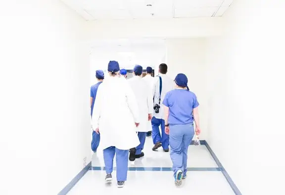 A group of medical professional walking down a hallway