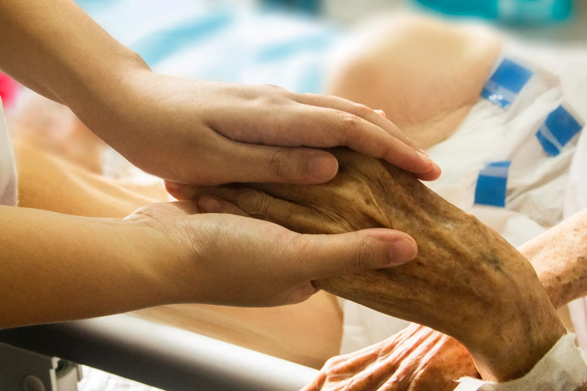 a caretaker holding hand of elderly patient