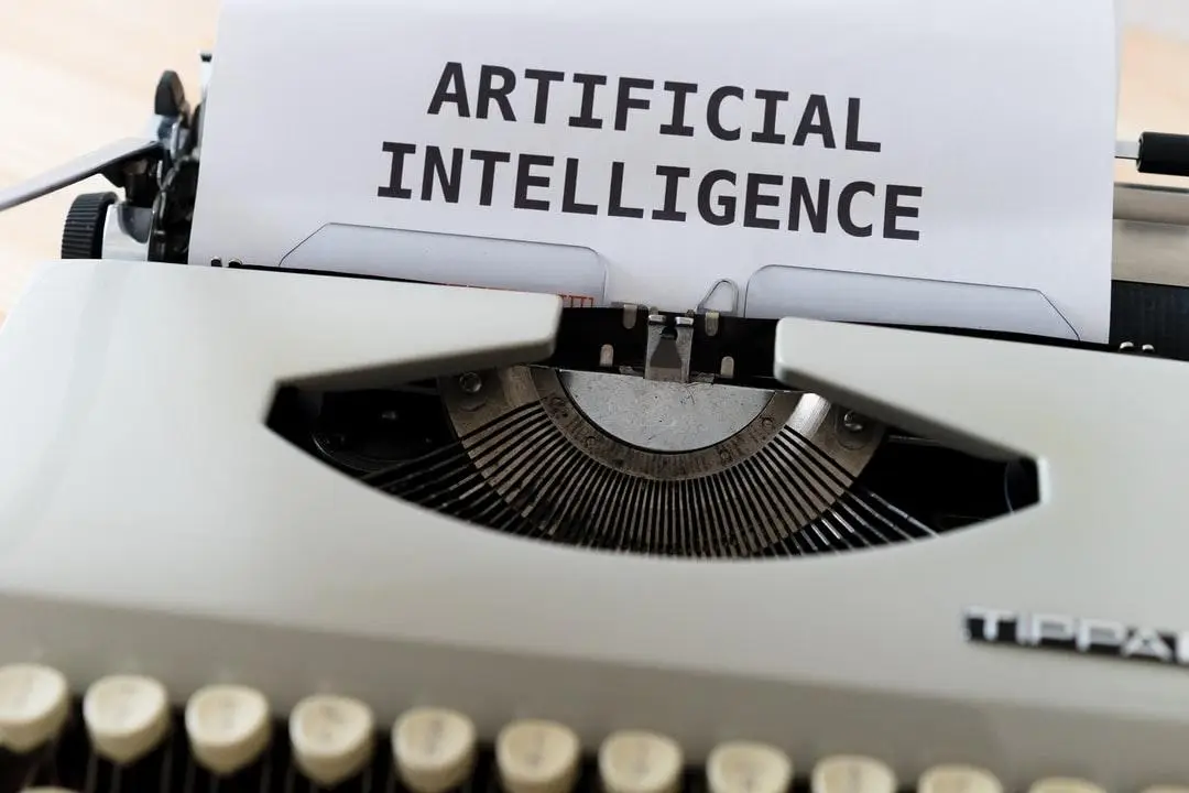 Words "artificial intelligence" written on a page in a typewriter